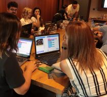 A group of teachers with laptops and equipment during a workshop