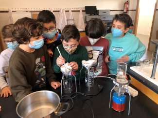 Students working with beakers and funnel