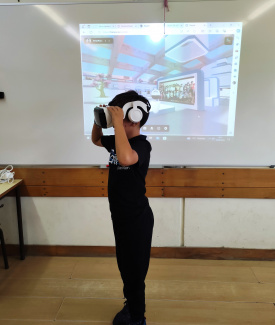 A boy with VR headset in front of a screen